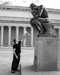 Robin Williams offering a toilet roll to  The Thinker
