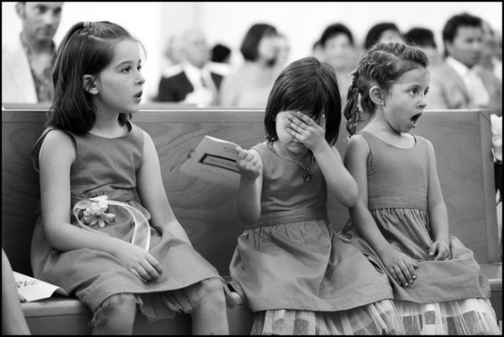  Little girls react to the kiss at a wedding