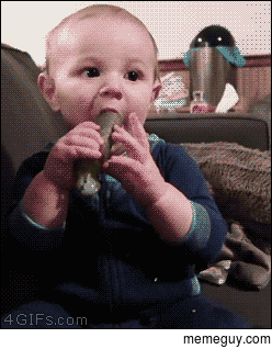 A baby reacts to a pickle