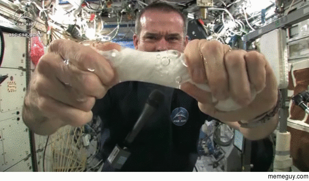 Astronaut wringing a wash cloth in space