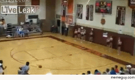 Basketball player drills a behind the back shot while dashing out the door