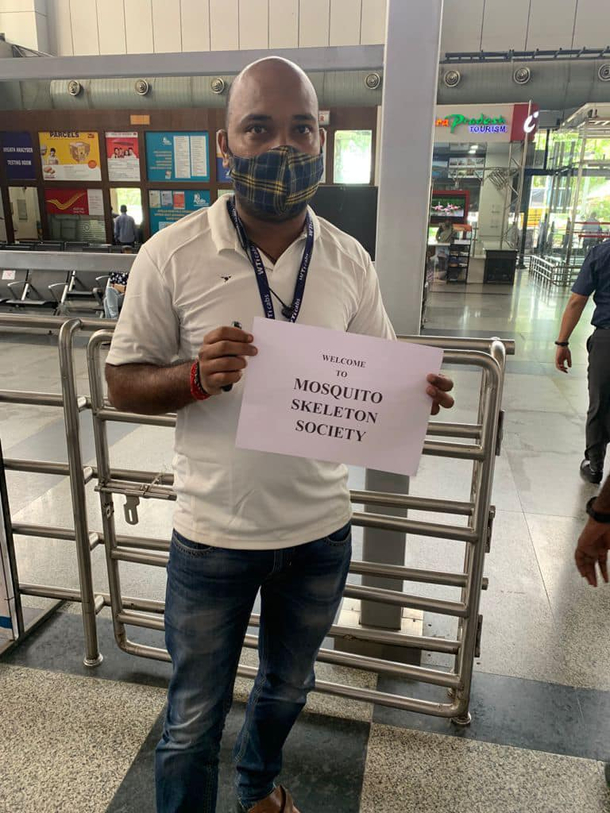 Driver with placard outside an Indian airport for delegates for Asian Musculoskeletal Conference