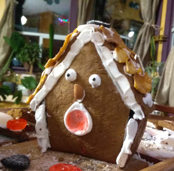 Gingerbread house is a little shocked that the kids have been picking at its candies
