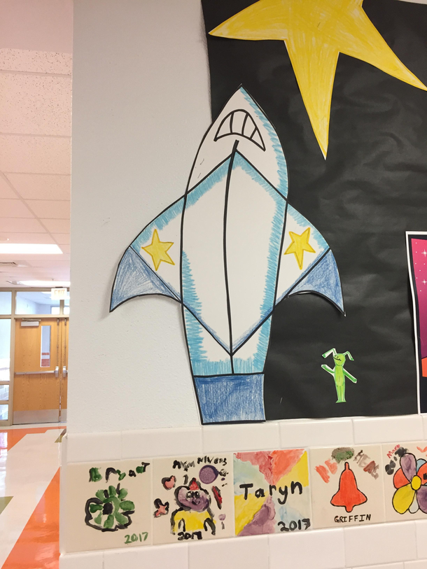 I was at my daughters school today I asked her why there was a shark ripping off its shirtmom thats a rocket ship