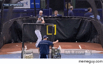 Matt Joyce hits a ball back into the pitching machine which throws it back at him
