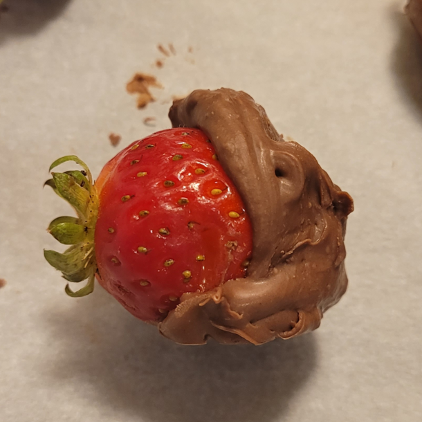 My wifes chocolate dipped strawberry looks like a chocolate hippo eating a really giant strawberry