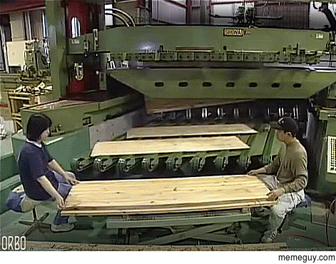 Slicing a huge block of wood into thin sheets of veneer