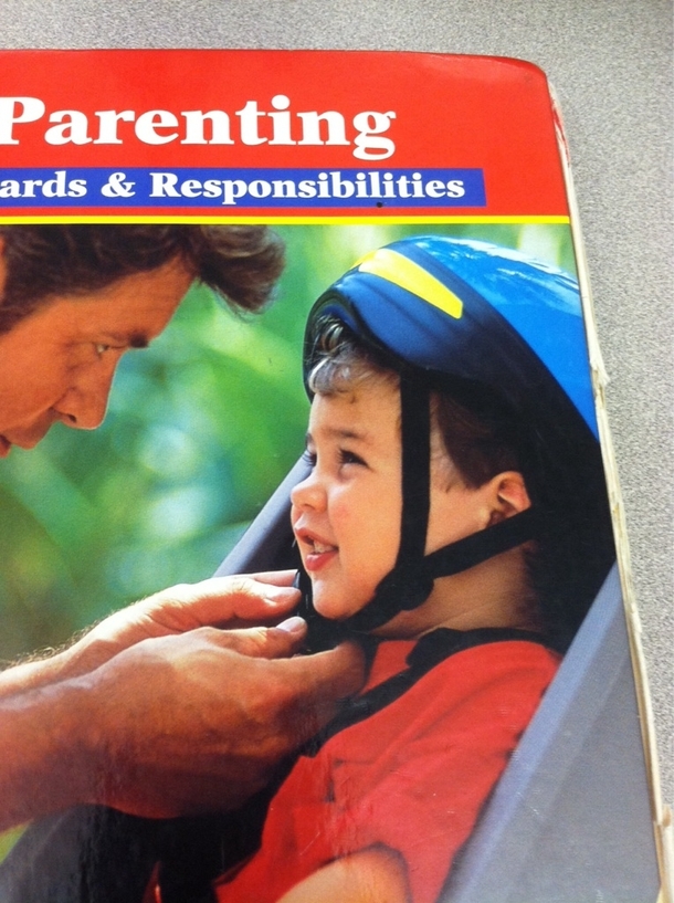 The dad on my Child Development book is putting the kids helmet in backwards