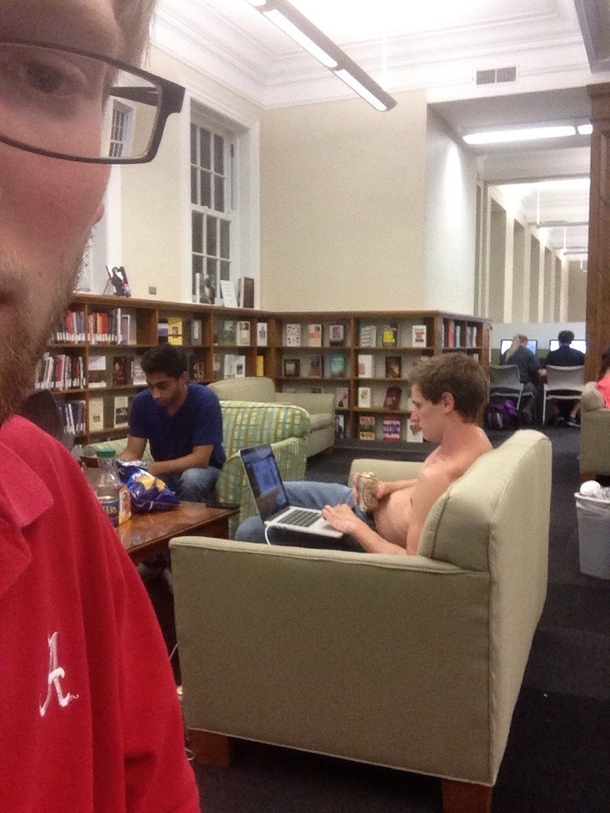 Theres a guy studying for finals drinking beer shirtless in the library
