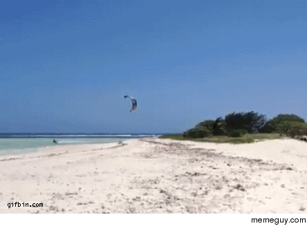 This guy is a total badass Kite surfer jumps over island