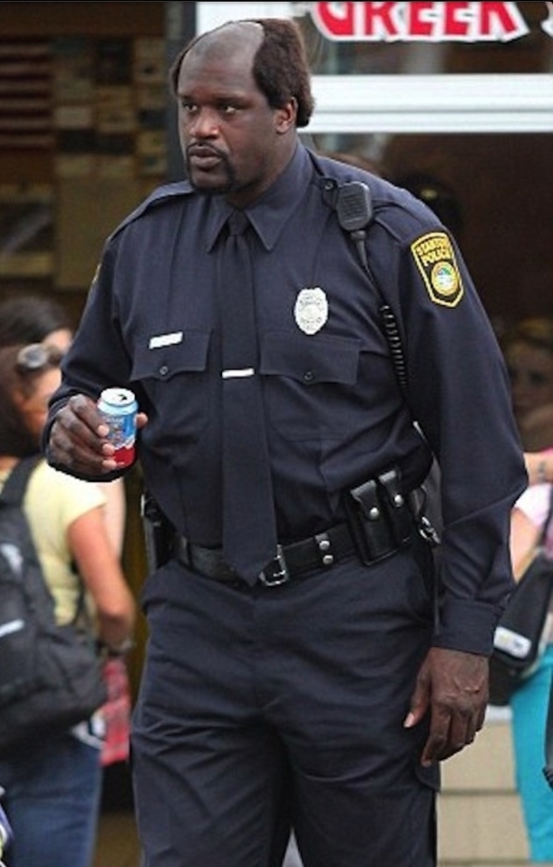 This is Shaq holding a  ounce can of soda