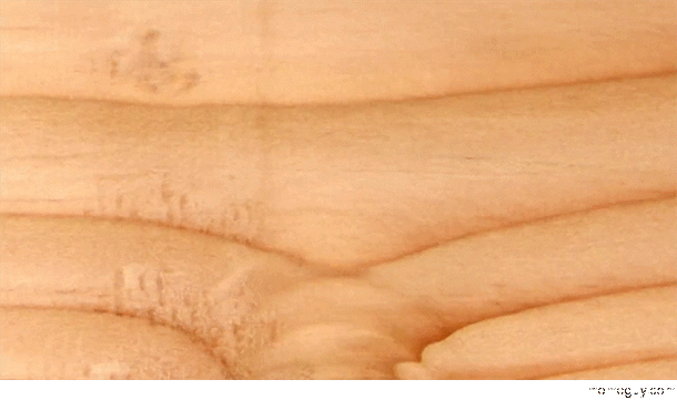 Time lapse of wood grain changing as it is shaved