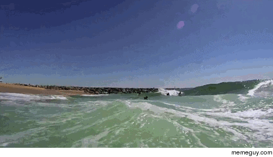 Wave catches surfer