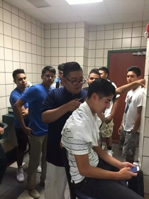  Friend in high school sent me this pic after he got done taking a shit and saw all these guys in the bathroom waiting to get a haircut by another kid