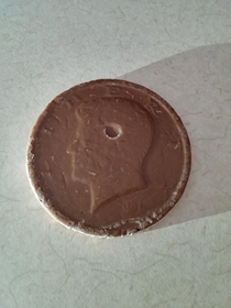 A bubble formed and popped on my chocolate coin featuring Kennedy