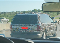 A car with hot wheels glued on it