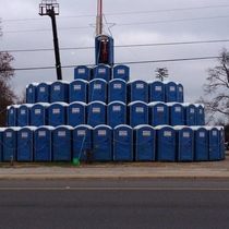 A local equipment rental place makes a porta potty Christmas tree every year with Santa at the top