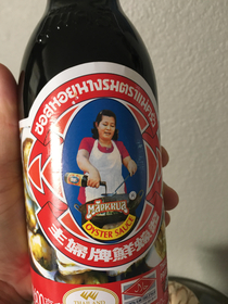 A picture of a lady cooking holding a sauce bottle with a picture of her cooking holding a sauce bottle with a picture of her cooking holding a sauce bottle with a picture of her cooking holding a sauce bottle with