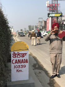 A Road Sign in Punjab India km to Canada