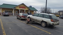 An Outback pulling an Outback stopped to eat at Outback parked outback