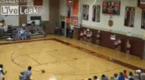 Basketball player drills a behind the back shot while dashing out the door