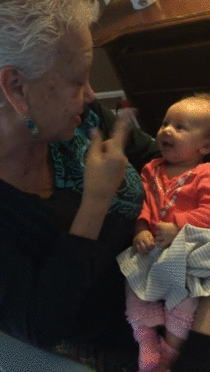 Deaf grandmother teaching  weeks old deaf baby sign language