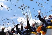 defenseless graduates flee as planes bombard the stadium with hats