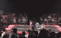 Fans throw hundeds of chairs at a wrestler