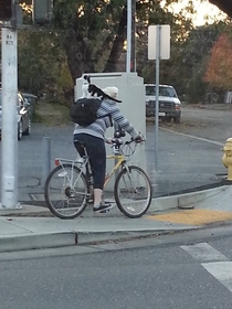 Finally saw something reddit worthy today after years of lurking sorry for the poor quality Thats a cat riding a person who is riding a bike 
