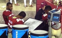 Football players playing hangman during a game