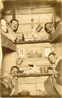 Four German soldiers in bunk beds who had been woken up for a surprise photograph during World War 