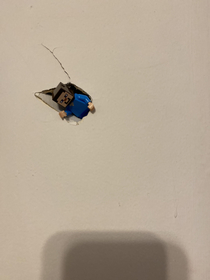 I accidentally poked a hole in wall and fixed it like this my parents dont like it as much as I do