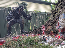 I added a Spawn action figure next to my neighbors fairy garden Horror descends upon Fairytown