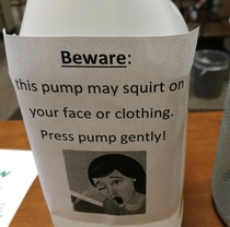 Ill advised but hilarious warning sign on the hand sanitizer dispenser at work