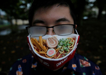 Japanese artist creates ramen face mask to complement fogged glasses via Reuters TW