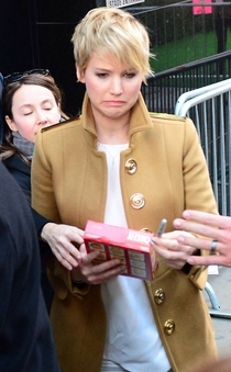 Jennifer Lawrence autographing a box of Cheeze-Its