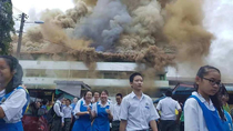 Malaysians students smiled as they evacuate from their burning school building