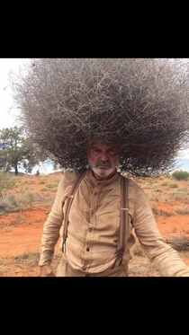 Man wearing tumbleweed on his head