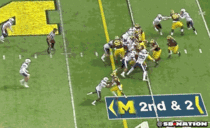 Michigan running back disappears into pile Emerges on other side like its a magic trick