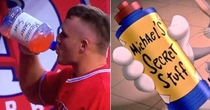 Mike Trout in the dugout drinking out of a Space Jam Inspired bottle