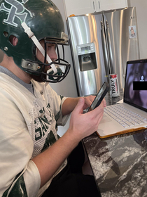 My BIL doing his fantasy football draft in his HS football uniform and helmet  hes 