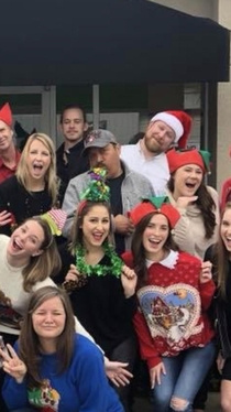 My coworker looks like he is spewing Christmas joy all over the girl in front of him