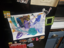 My daughter used her animal magnets to hang up a finger painting