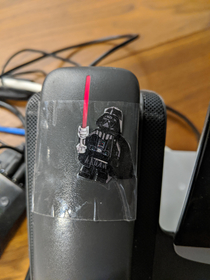 My friend never listens to his work voicemails hence the red light so I cut out a Darth Vader Lego and lined it up