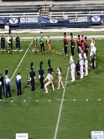 My local university had a marching band competition and one of the colorguard uniforms made them look naked I caught a pic right as it looks like hes about to take a dump Potato quality