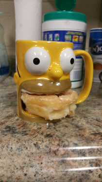 My roommate coffee mug holds a donut