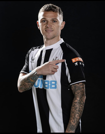 Newcastles newly-signed player Trippier points at the sponsor logo instead of the teams badge