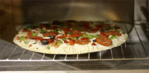 Pizza being cooked in an oven