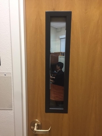 Professor at my local university has photo of him sitting at his desk on the window