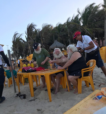 Santa Claus drinking beer on the beach after the x-mass